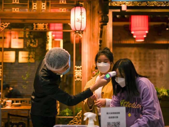 Photos show how table dividers and temperature checks are becoming the new normal at restaurants in Hong Kong, Taipei, and more