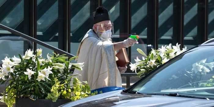 A Michigan priest sprayed holy water on people with a squirt gun for drive-thru blessings