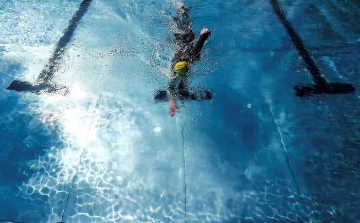 It's pretty safe to swim in a pool during the coronavirus pandemic. Just avoid the locker room and keep moving.