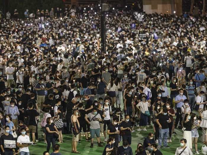 Photos show thousands of Hong Kongers defying a police order to attend vigils memorializing the victims of the Tienanmen Square massacre