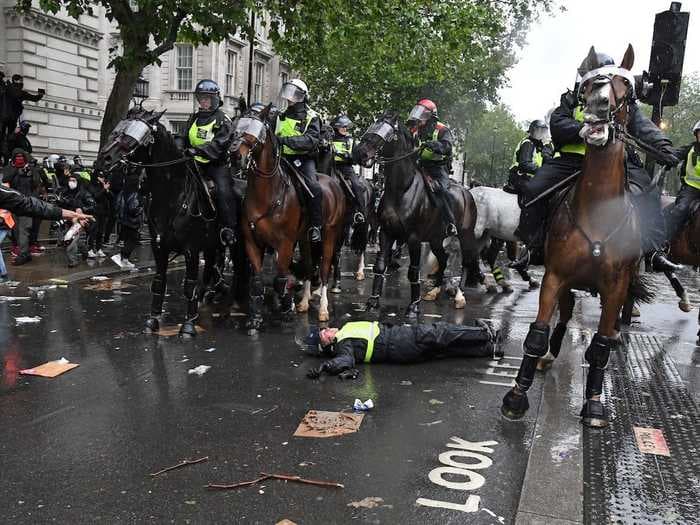 Dramatic video of the moment a police officer on horseback smashed into traffic lights during a charge at anti-racism protesters in London