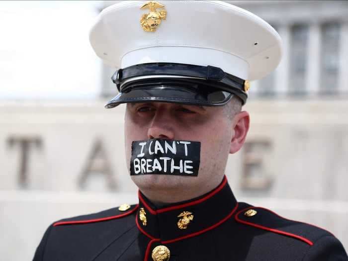 A US Marine veteran stood outside the Utah Capitol with the words 'I can't breathe' taped over his mouth for so long that his shoes started melting into the ground