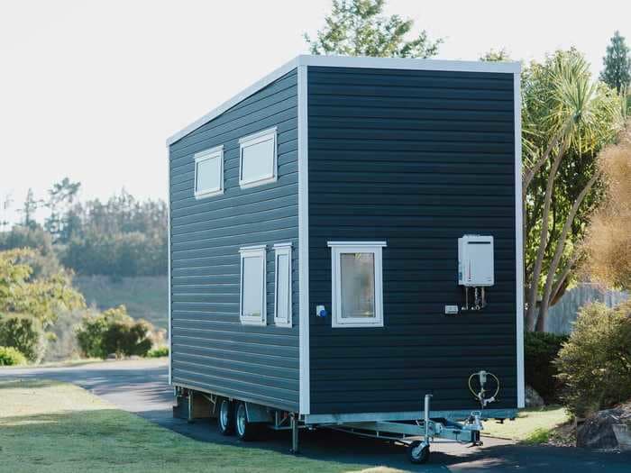 Leftover building materials were used to create a 2-story, 20-foot long tiny home on wheels for $84,746 — see inside 'Bitser'