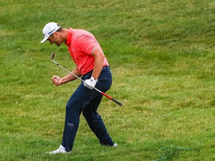 New world No. 1 golfer Jon Rahm took a 2-stroke penalty after hitting a Tiger Woods-like shot of a lifetime, and it cost one unlucky bettor $150,000