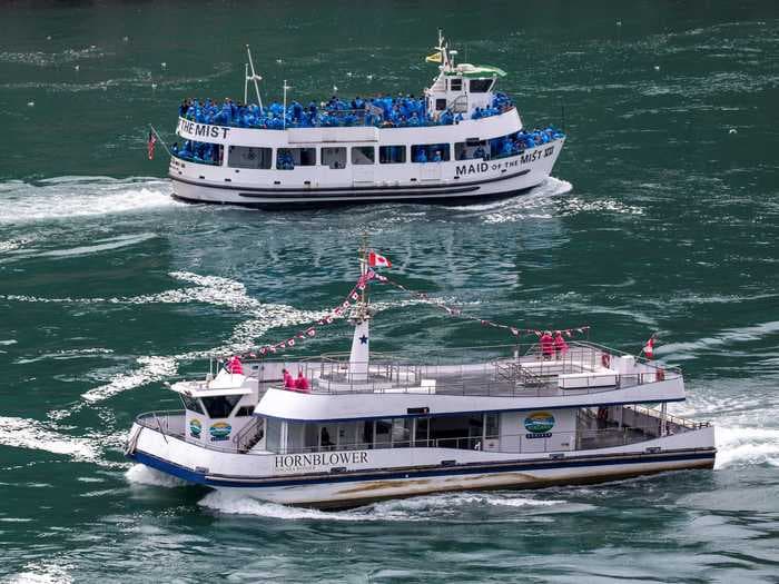 Photos of 2 tourist boats at Niagara Falls, one American and one Canadian, show how differently the countries are responding to the pandemic