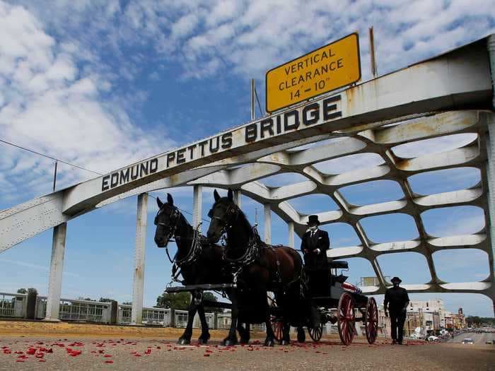 Photos show Congressman John Lewis crossing the infamous Edmund Pettus Bridge one last time