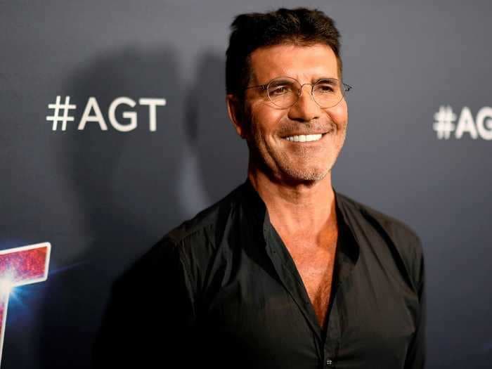 Simon Cowell is reportedly home and 'able to walk quite a lot' after having surgery on his broken back a week ago