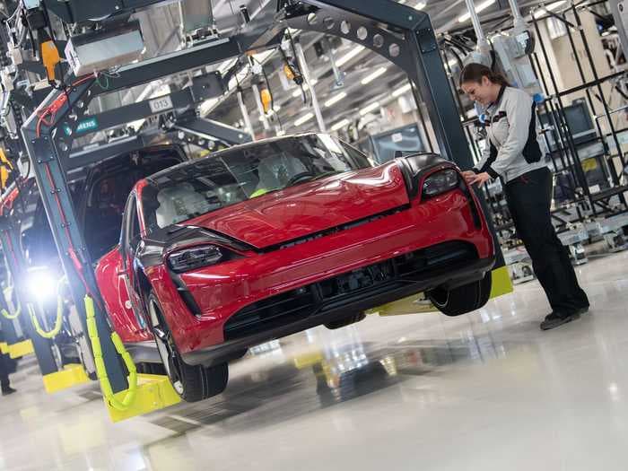 Porsche is selling so many all-electric Taycans, it's borrowing hundreds of Audi workers to ramp up production