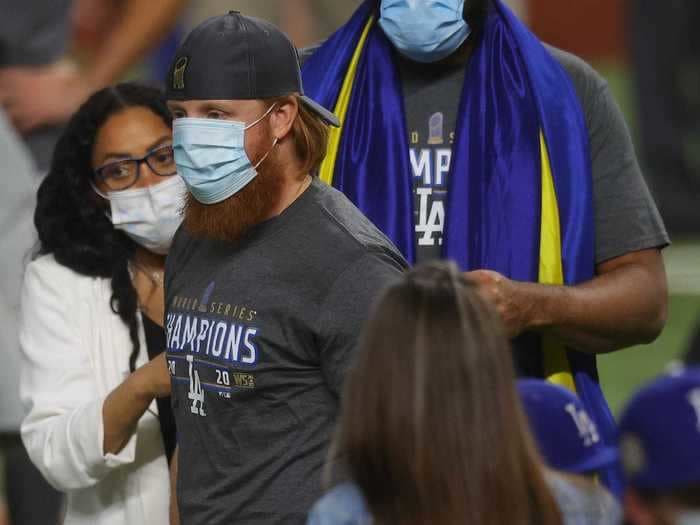 Photos show Justin Turner celebrating the Dodgers' World Series win hours after testing positive for coronavirus, giving handshakes and hugs to his teammates