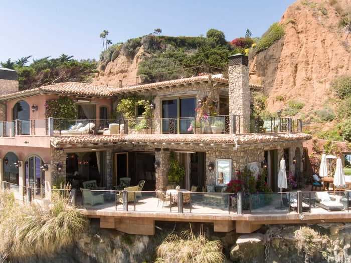 The billionaire CEO of Paycom just paid $26.5 million for a beachfront Malibu mansion that took 12 years to build and blends into the rocks. Take a look inside.