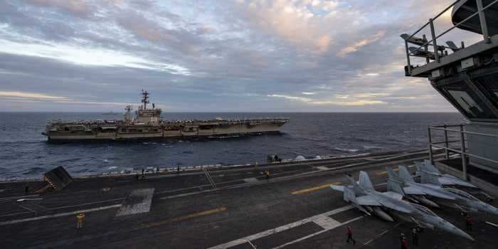 2 US Navy carrier strike groups drill together in the disputed South China Sea, sparking complaints from Beijing