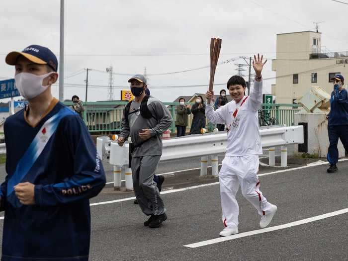 Eerie photos of the Tokyo Olympic torch relay show just how different this year's Games will be to pre-pandemic predecessors