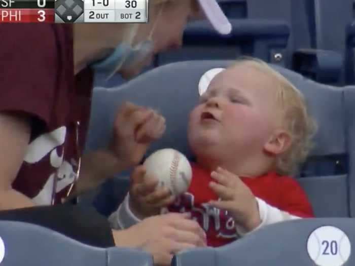 Look at this Phillies baseball baby attempt to eat a home run baseball