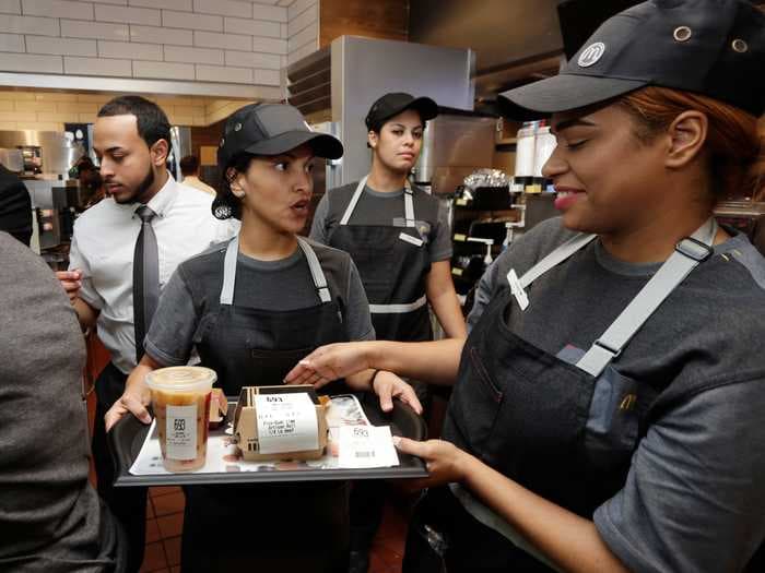 Fast food chains are offering cash bonuses, raises, and education benefits in order to hire enough workers