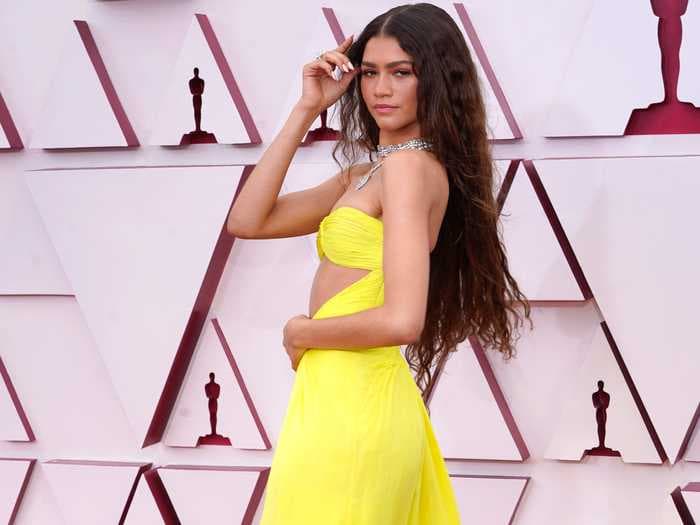 Zendaya wore a fluorescent-yellow dress with a cutout across her waist at the Oscars