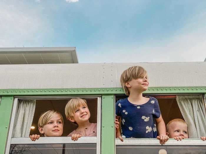 A couple with 5 kids spent $35,000 turning a school bus into a tiny home with a rainfall shower and skylight
