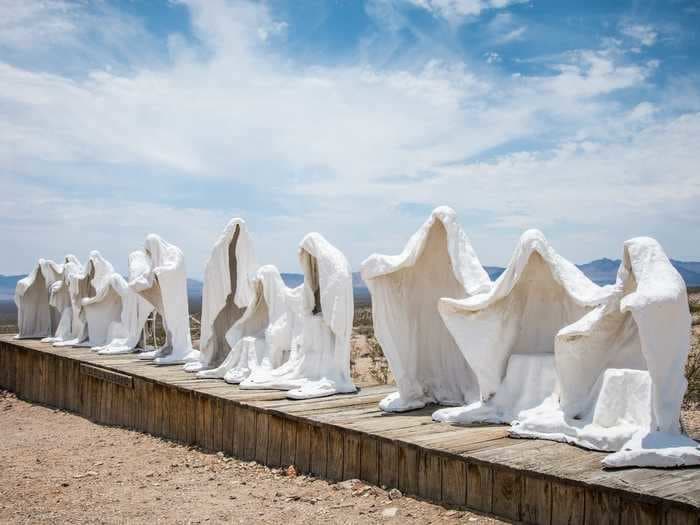 A TikToker's viral video shows a Nevada ghost town with 'creepy men in white cloaks' that are actually statues in an art exhibit