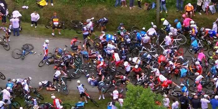 The woman who caused a crash at the Tour de France will be sued once police find her, official says