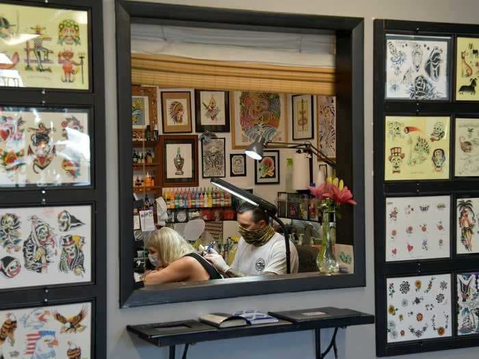 Tattoo and piercing shops are so overwhelmed with business that some are turning patrons away. Artists and owners say it's a sign that people are seeking out 'a moment of being raw' after a year of isolation.