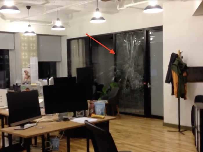 A video from a wild WeWork party shows the moment a bottle is thrown at former CEO Adam Neumann's glass office