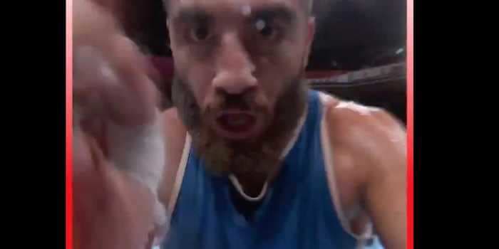 A French Olympic boxer punched a TV camera and sat in the ring for an hour to protest his disqualification