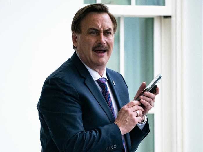 Here's what happened at Mike Lindell's cyber symposium, from him storming offstage to Bolsonaro's son giving him a MAGA hat signed by Trump
