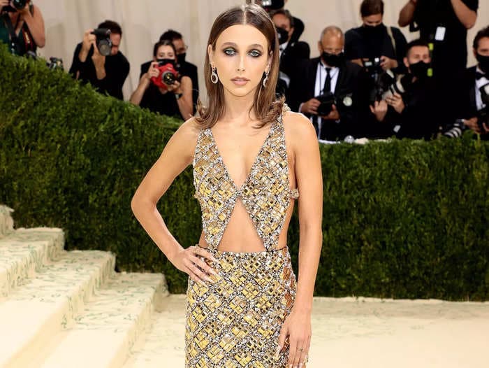 Emma Chamberlain glistened from head to toe in a gold dress with daring cutouts at the Met Gala