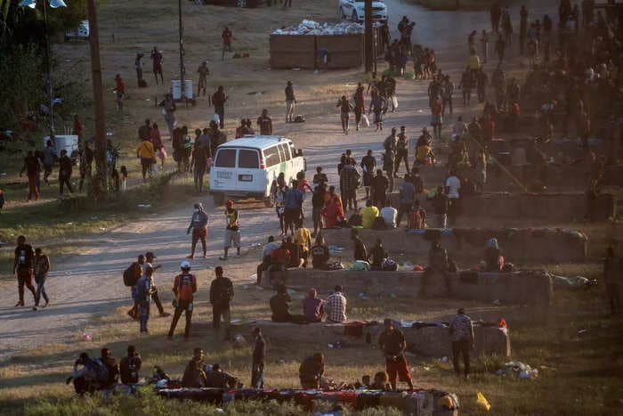 Videos show thousands of migrants in makeshift camp under bridge in Texas as they wait to be processed by the US