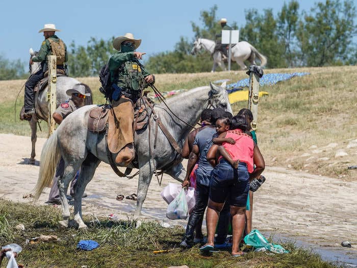 Video shows Border Patrol agent on horseback swing reins and charge at fleeing Haitian migrants