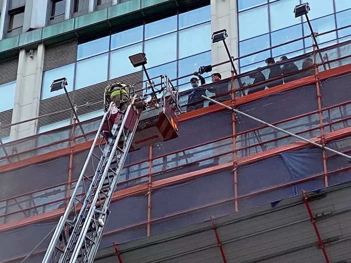 Hundreds of people were rescued from the roof of a 38-story skyscraper in Hong Kong after being trapped for hours by a fire