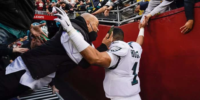 Fans fell from the stands in Washington and nearly squashed Eagles QB Jalen Hurts when a barrier collapsed
