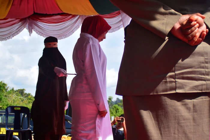 An Indonesian woman was flogged 100 times for adultery, while the man she had the affair with received 15 lashes after denying the accusations