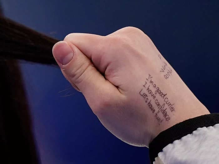 A Japanese curler wrote a simple message on her hand to inspire self-confidence