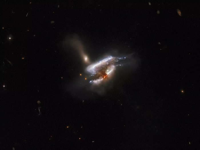 A stunning photo from NASA's Hubble Space Telescope reveals 3 galaxies colliding