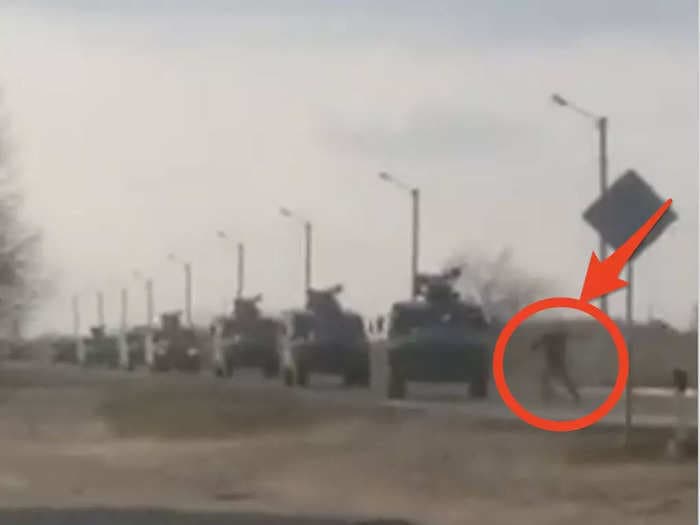 Video shows a lone Ukrainian man trying to halt a Russian convoy of armored vehicles
