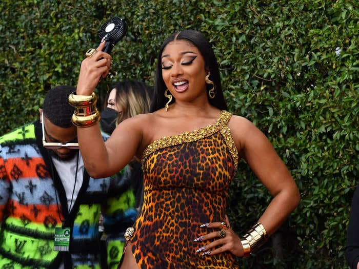 Megan Thee Stallion walked the Grammys red carpet in a bold leopard-print dress with a thigh-high slit