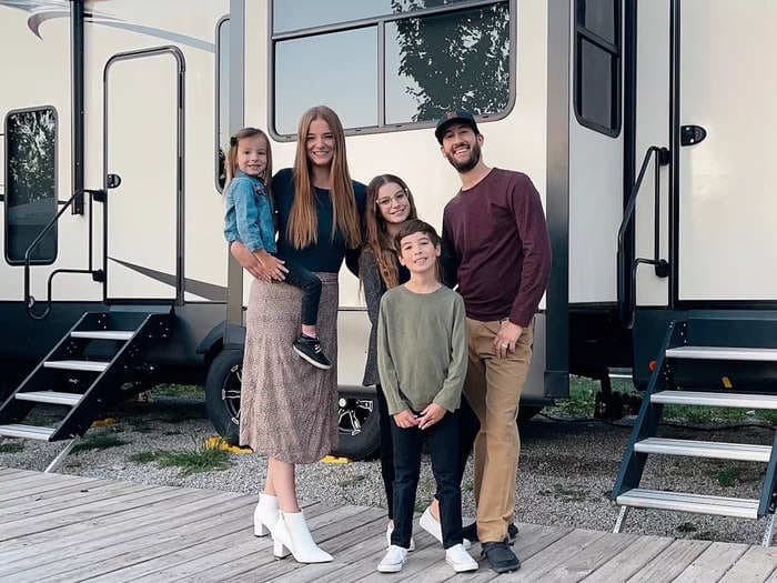 A family of 5 renovated a 2-story RV that's complete with a secret doorway, hidden projector, and fireplace