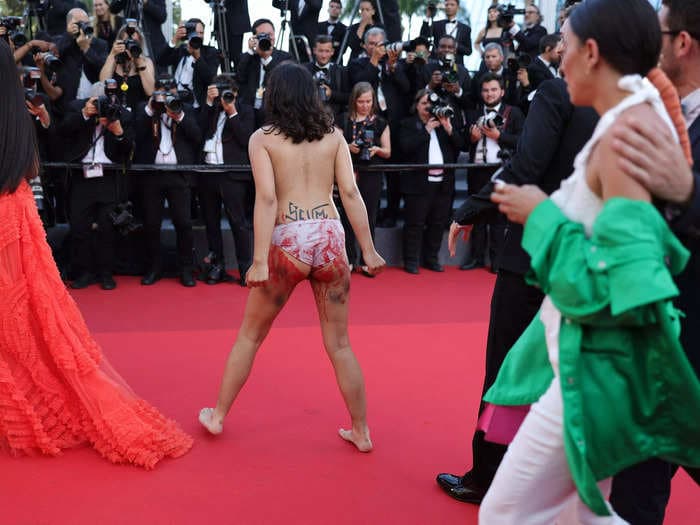 Topless woman storms Cannes Film Festival red carpet to protest against Russian rapes in Ukraine, photos show