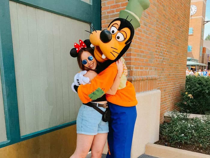 A woman is speaking out against critics of Disney adults after she was bullied online for crying while hugging Goofy