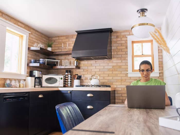 Companies are letting you work from home so they can pay you less &mdash; and so you'll be happier