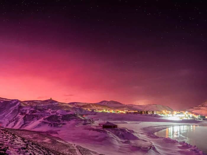 Amazing photo shows Antarctica bathed in pink light after a volcano eruption spewed particles in the atmosphere