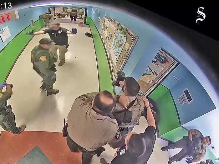 Newly released body cam footage shows Uvalde police trying to negotiate with the suspect after hearing gunshots and learning children were in the classroom: 'This could be peaceful'