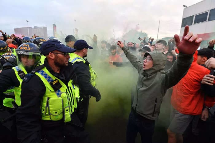 Manchester United fans sang about killing the club's owner and threw bottles at opposition fans during a protest, reports say