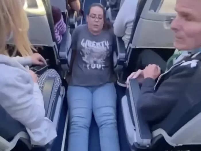 A wheelchair user who was filmed dragging herself toward an airplane bathroom said the cabin crew had refused to help