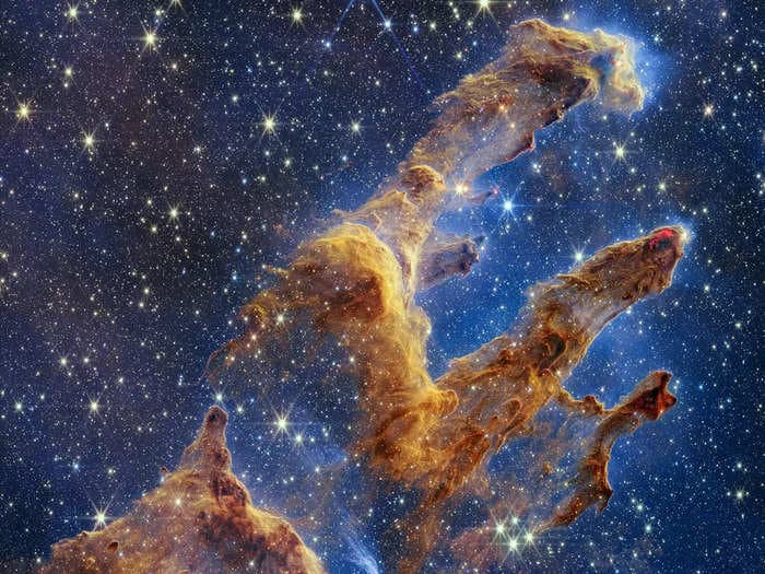 Side-by-side images of the 'Pillars of Creation' show Webb's power. It captured the famous stellar nursery overflowing with stars, which Hubble couldn't make out.