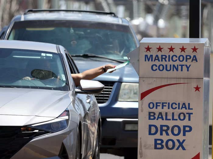 Armed and masked 'ballot watchers' sat by a ballot drop box in Arizona, prompting police investigation