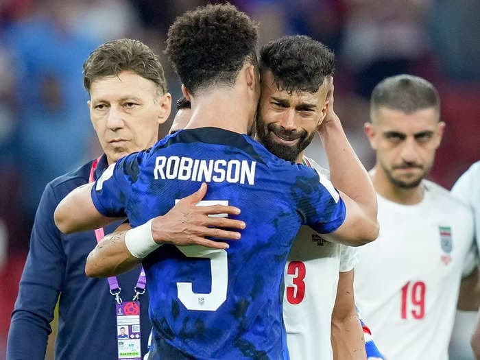 USA's Antonee Robinson comforted a sobbing Iranian soccer player after the Americans knocked their team out at the World Cup