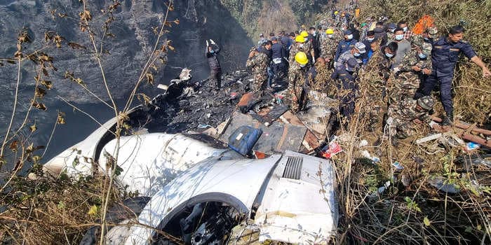 Video shows passenger plane that crashed in Nepal flying low over a populated area before spinning sharply. At least 68 reported killed.