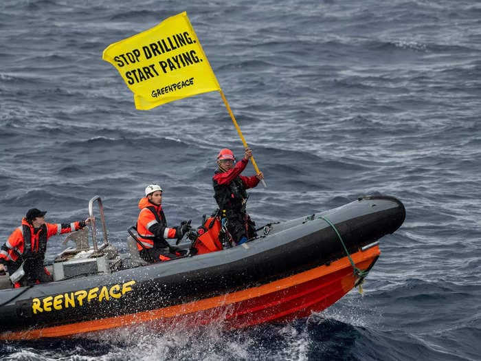 Footage shows the moment Greenpeace activists scaled a Shell oil platform that was being transported in 'rough conditions' in the Atlantic