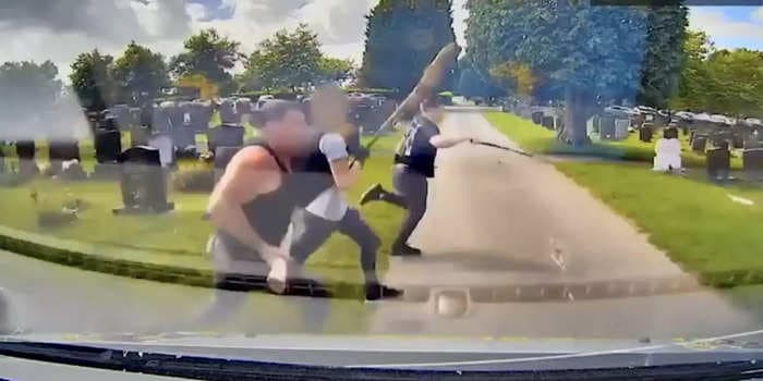 Disturbing video shows a brawl breaking out in a UK cemetery as warring families brandish machetes, hammers, and baseball bats